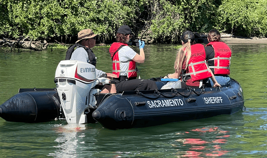 Interns learn about patrol on the river. 